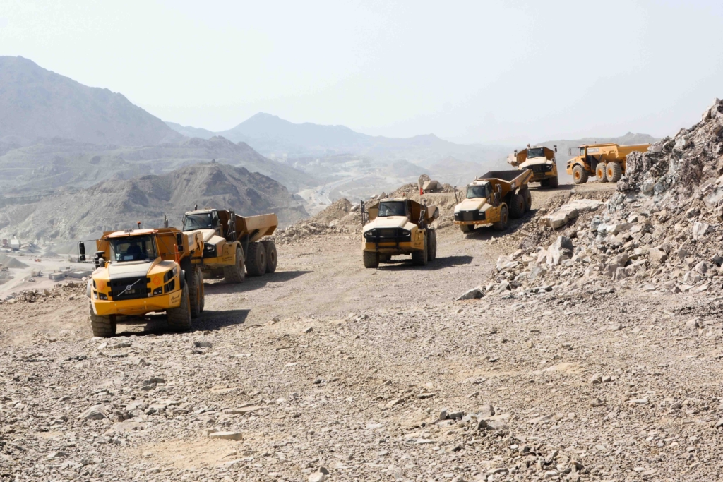 Articulated dump truck navigating rough terrain during safe operation.
